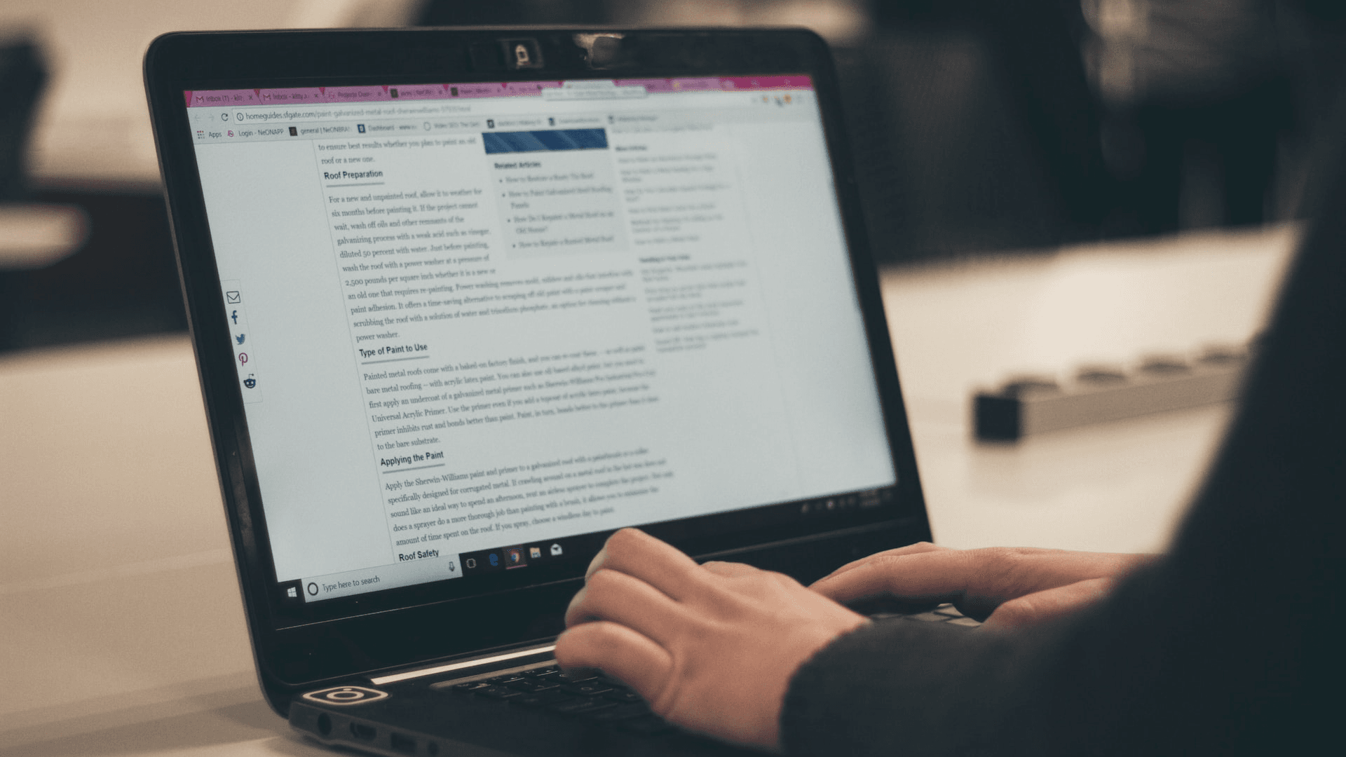 A Person is writing article on Laptop